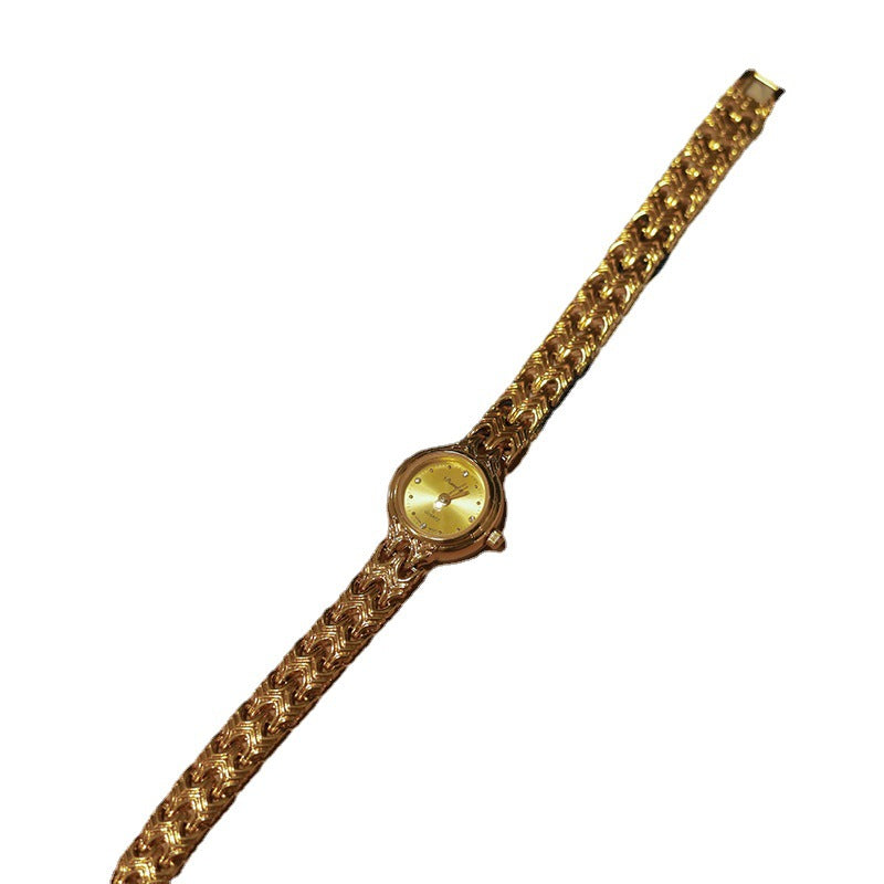 Reloj medieval con tiras de cobre tejidas