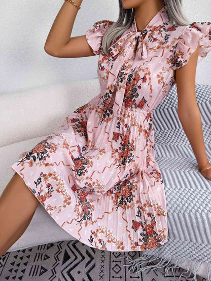 Vestido hasta la rodilla con cuello anudado y estampado floral plisado