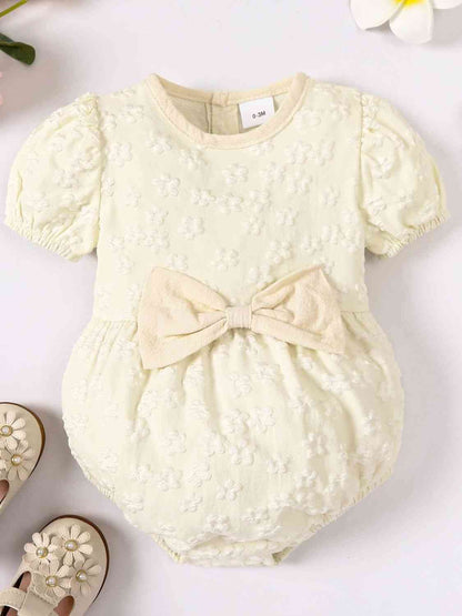 Body de bebé niña con detalle de lazo floral y cuello redondo